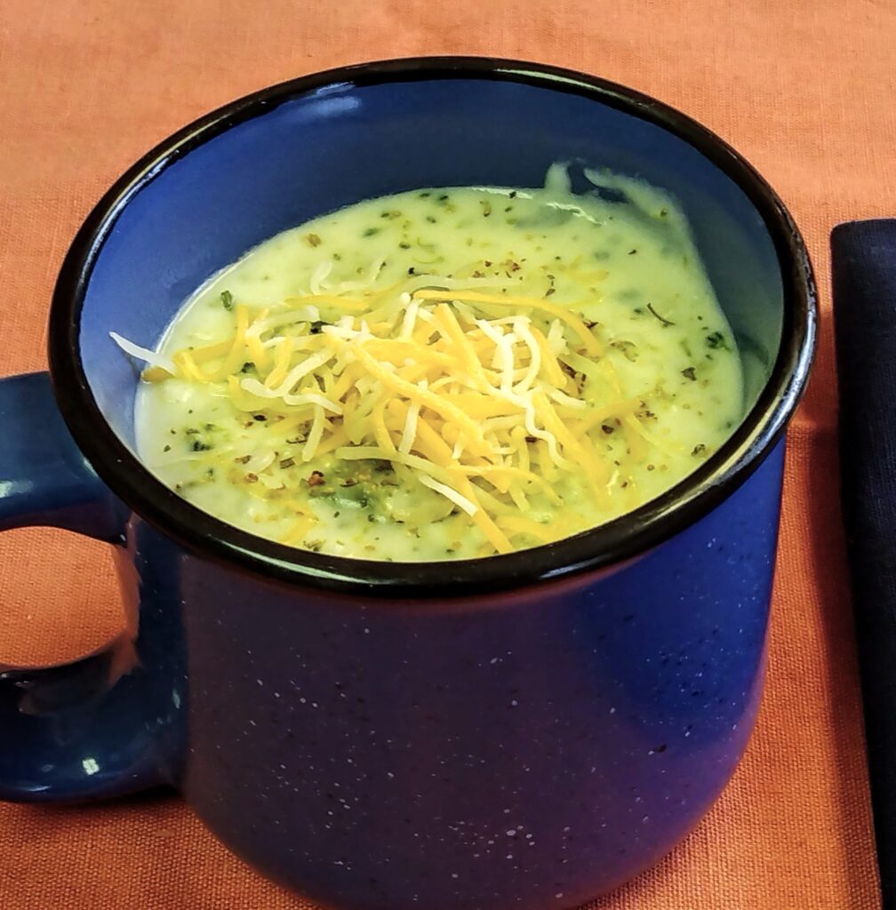 creamy chunky broccoli and cauliflower soup with cheese and montreal chicken